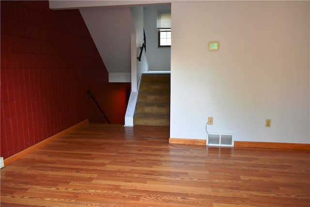 staircase with hardwood / wood-style floors