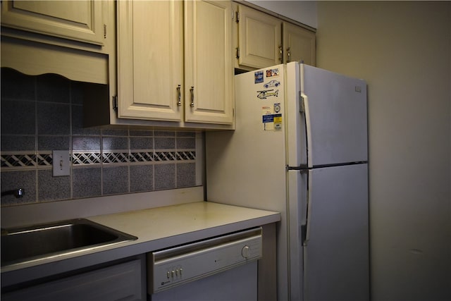 kitchen with tasteful backsplash, dishwasher, and white refrigerator