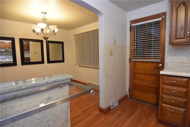 bathroom featuring wood-type flooring and a chandelier