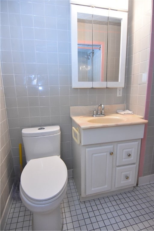 bathroom featuring tile patterned flooring and tile walls