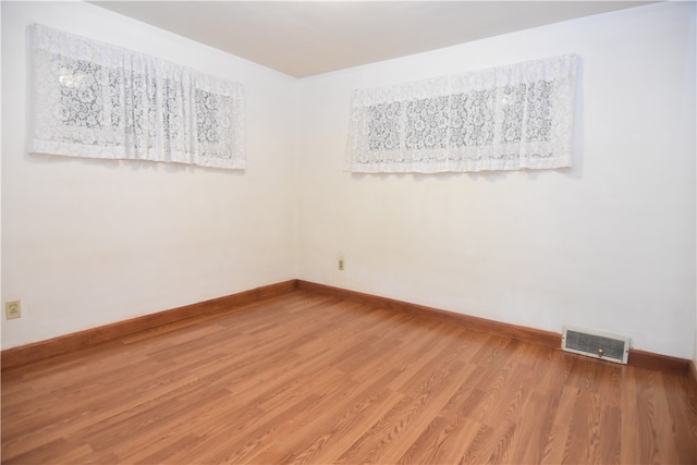 spare room with hardwood / wood-style floors