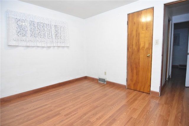 spare room featuring light hardwood / wood-style flooring