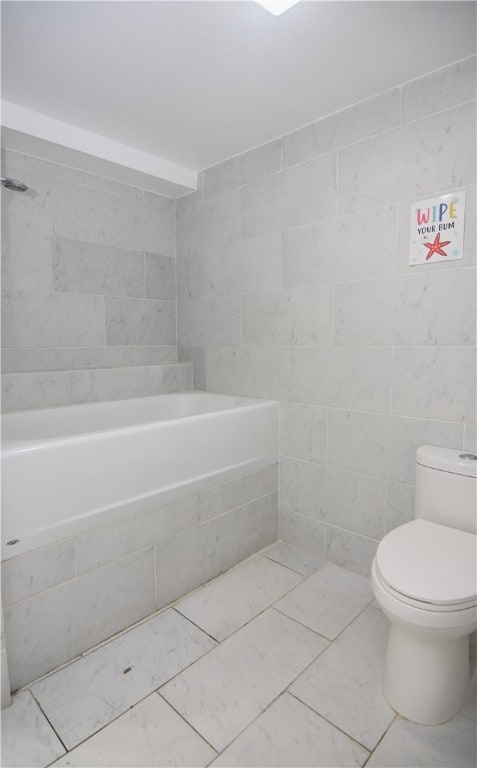 bathroom featuring tile patterned flooring, toilet, and tile walls