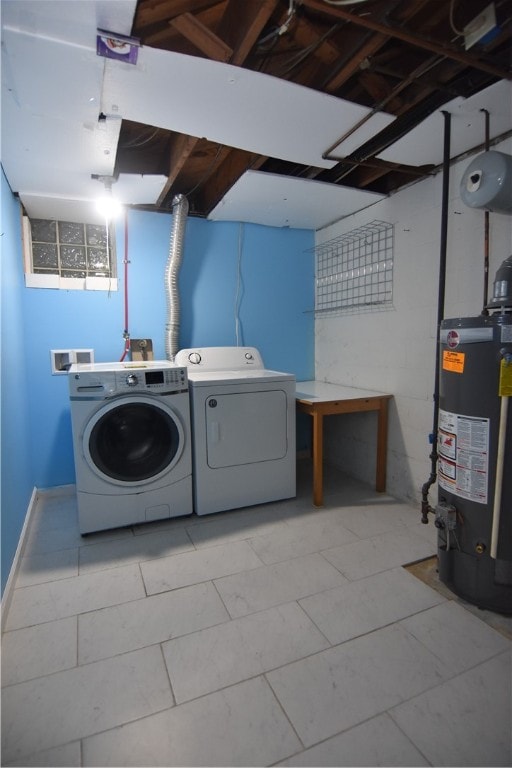 laundry area featuring water heater and independent washer and dryer