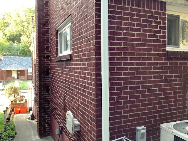 view of side of home with central air condition unit