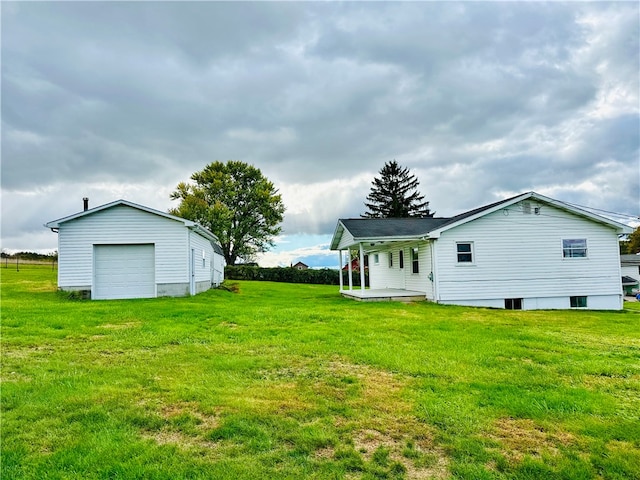 exterior space featuring a garage and an outbuilding