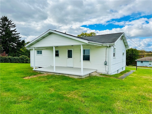 rear view of property with a lawn