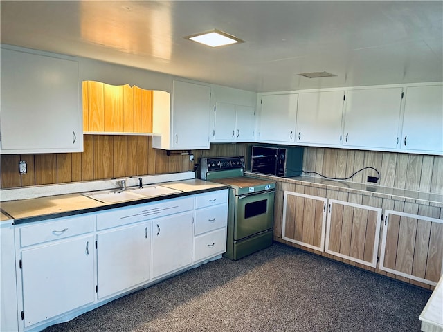 kitchen featuring sink, white cabinetry, and electric range