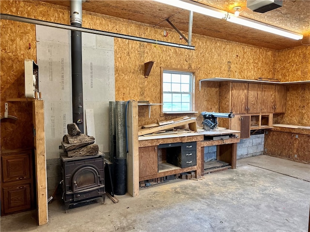 miscellaneous room with concrete floors and a workshop area