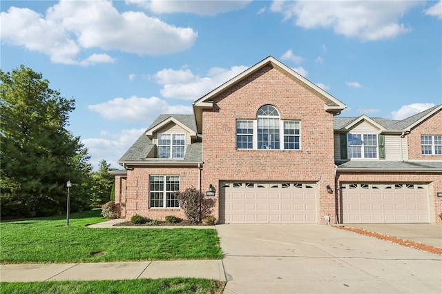 view of front of house featuring a front lawn and a garage