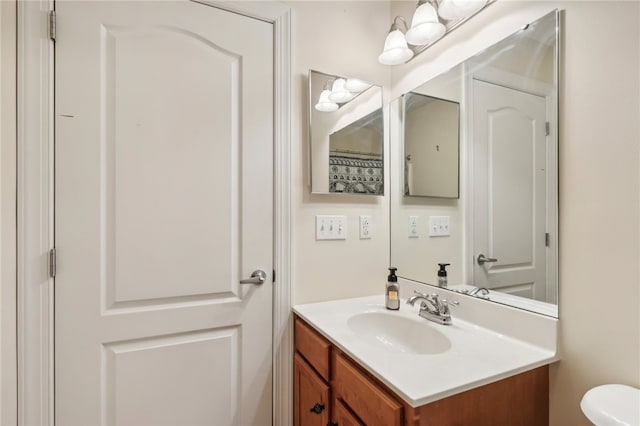 bathroom featuring vanity and toilet