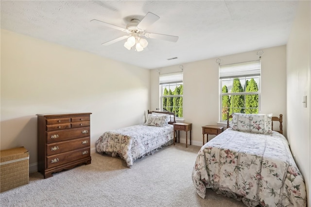 bedroom with ceiling fan and carpet