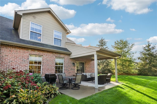 rear view of property with a patio area, an outdoor living space, and a lawn