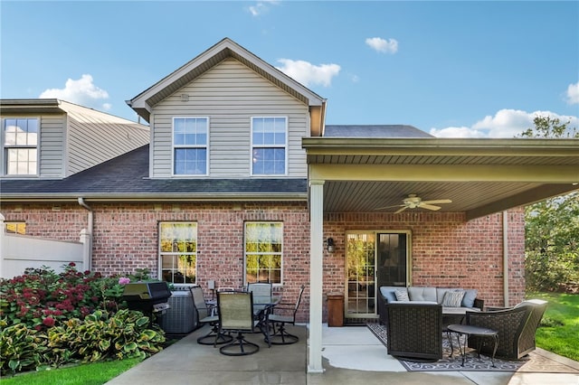 rear view of property featuring an outdoor living space, a patio area, and ceiling fan