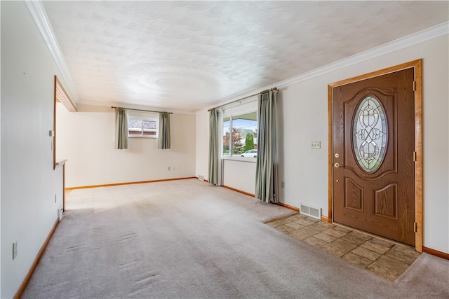 carpeted entryway with crown molding