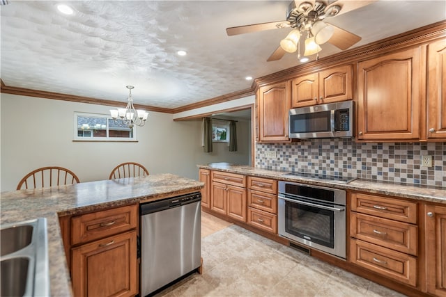 kitchen featuring tasteful backsplash, light stone countertops, hanging light fixtures, stainless steel appliances, and ornamental molding