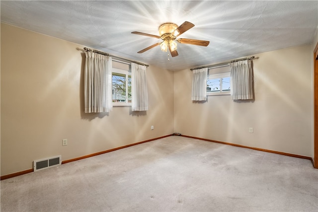 spare room with carpet and ceiling fan