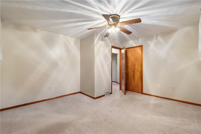 carpeted empty room featuring lofted ceiling, a textured ceiling, and ceiling fan