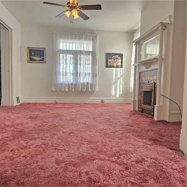 unfurnished living room with carpet floors and ceiling fan