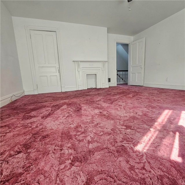 unfurnished living room featuring carpet flooring