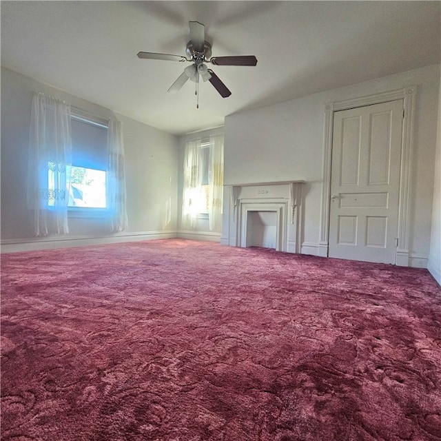 unfurnished living room featuring carpet flooring and plenty of natural light