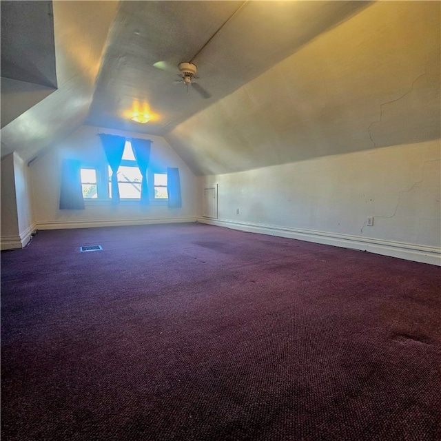 additional living space with lofted ceiling, carpet floors, and ceiling fan