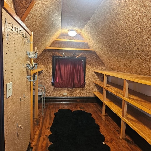 bonus room featuring dark wood-type flooring and vaulted ceiling