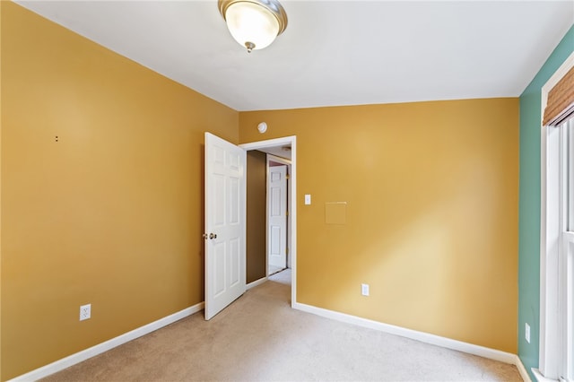 unfurnished bedroom with vaulted ceiling and carpet floors