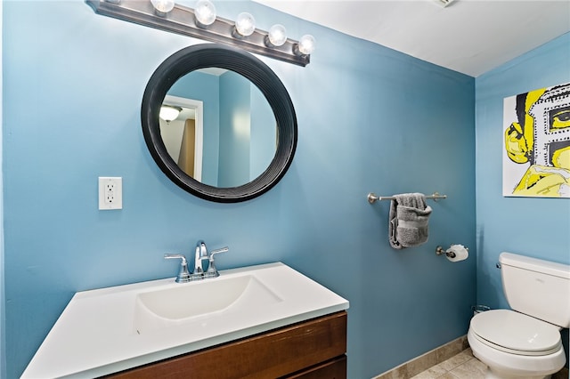 bathroom with vanity, toilet, and tile patterned flooring