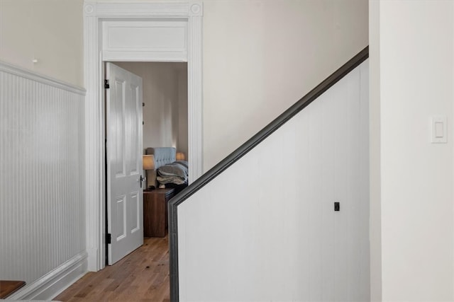 stairway with hardwood / wood-style flooring