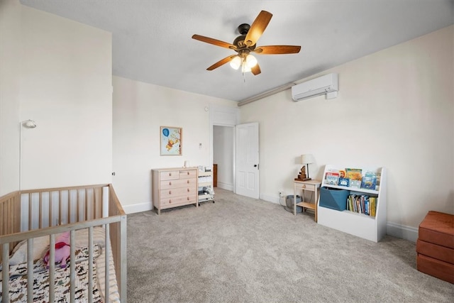 carpeted bedroom with a wall mounted AC, a crib, and ceiling fan