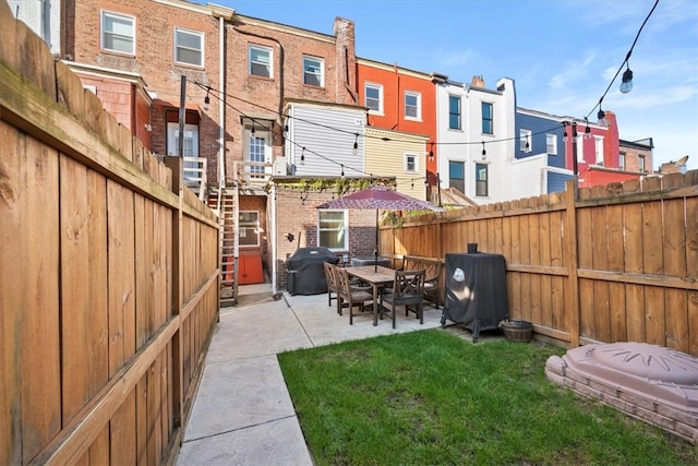 back of property with a patio and a lawn