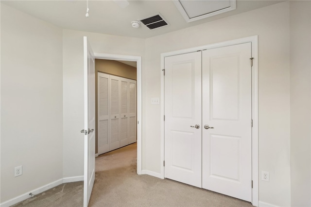 unfurnished bedroom featuring light carpet