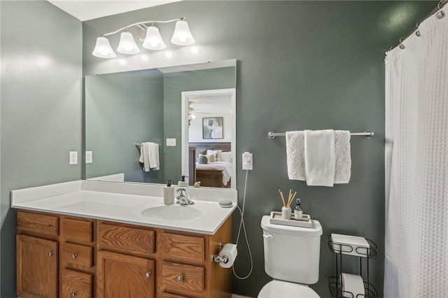 bathroom featuring vanity, toilet, and ceiling fan