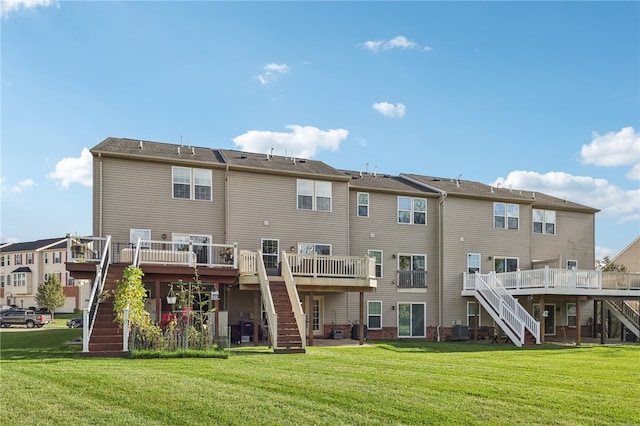 back of house featuring central air condition unit, a deck, and a lawn