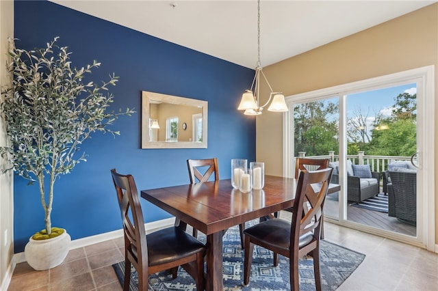 dining area featuring an inviting chandelier and tile patterned flooring