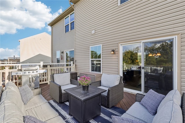 deck featuring an outdoor living space and a grill