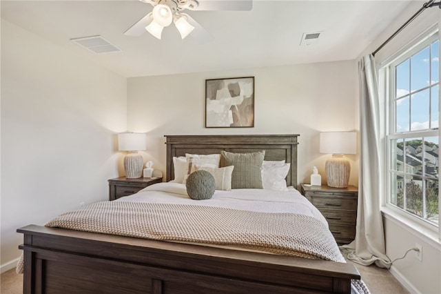 bedroom featuring light carpet and ceiling fan