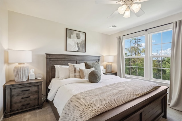 bedroom with light carpet and ceiling fan