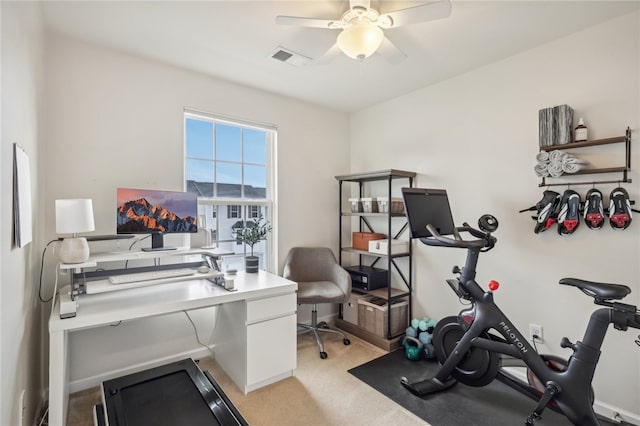 carpeted office space with ceiling fan