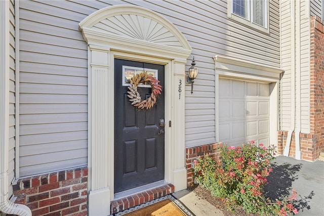 view of exterior entry featuring a garage