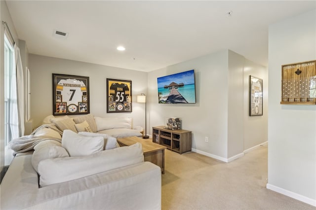 living room with a wealth of natural light and light carpet