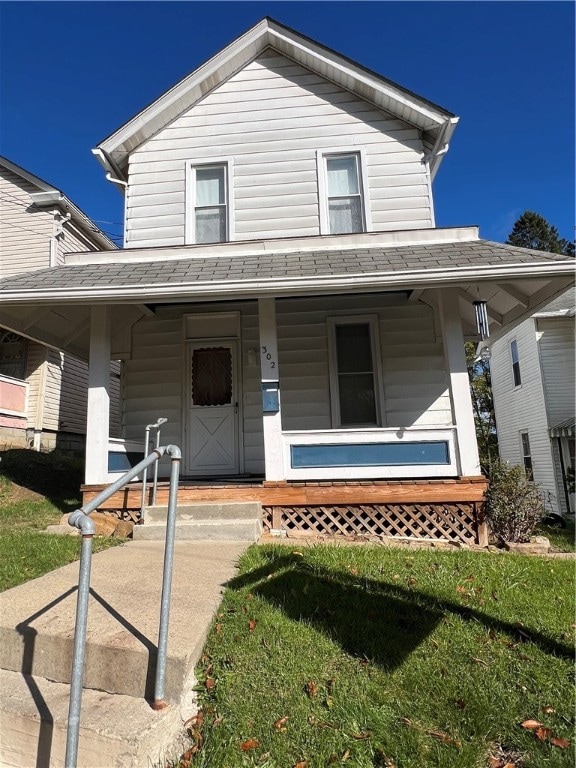 view of front facade with a front lawn and a porch