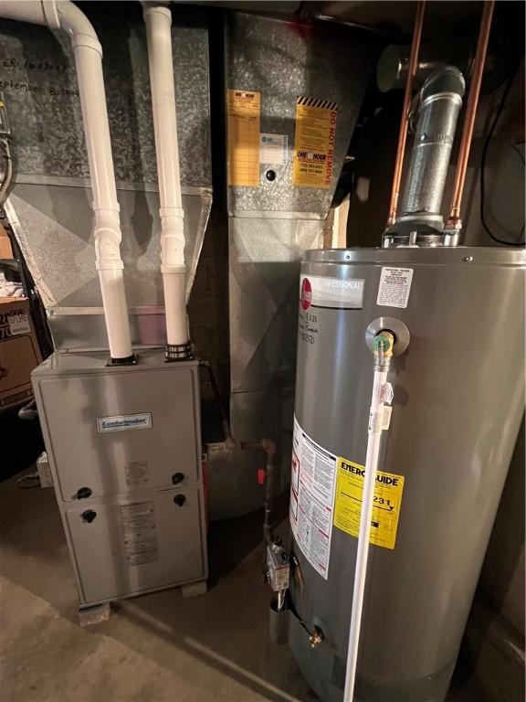 utility room featuring water heater