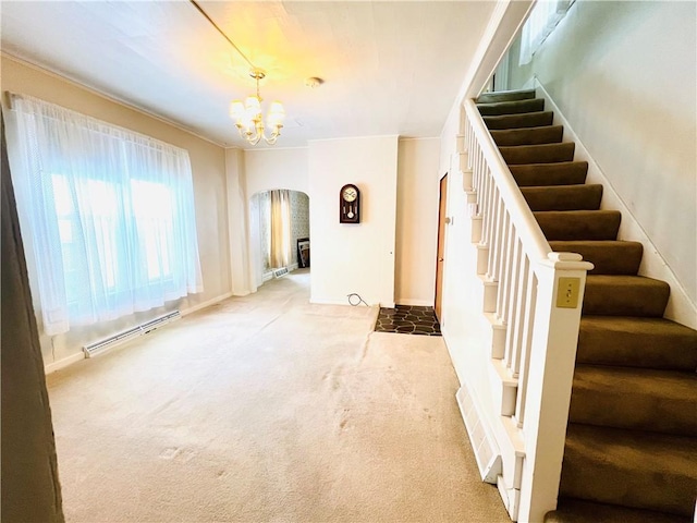 interior space with carpet flooring, a notable chandelier, and a baseboard heating unit