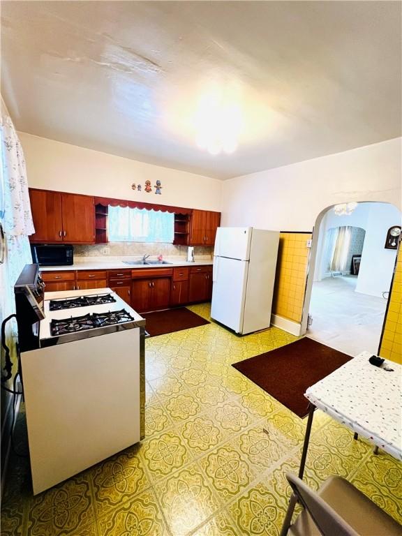 kitchen with white appliances and sink