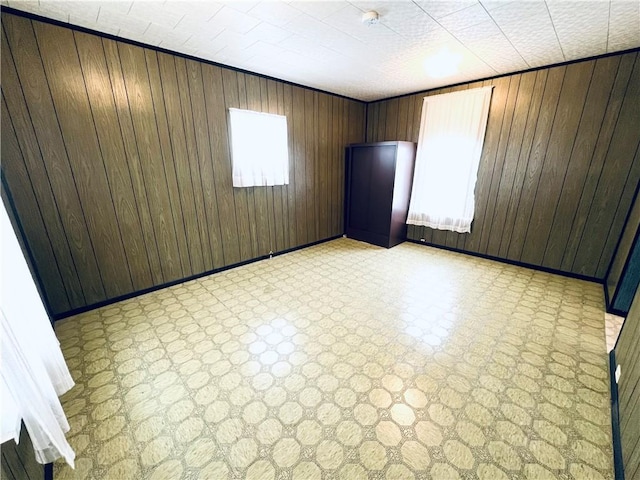 unfurnished room with wooden walls