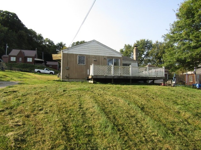 rear view of property with a lawn