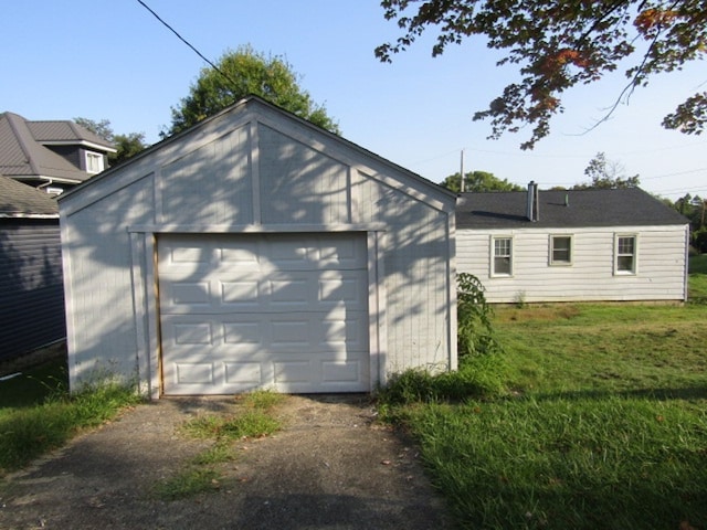 garage featuring a lawn