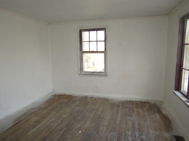 unfurnished room with ornamental molding and dark hardwood / wood-style floors